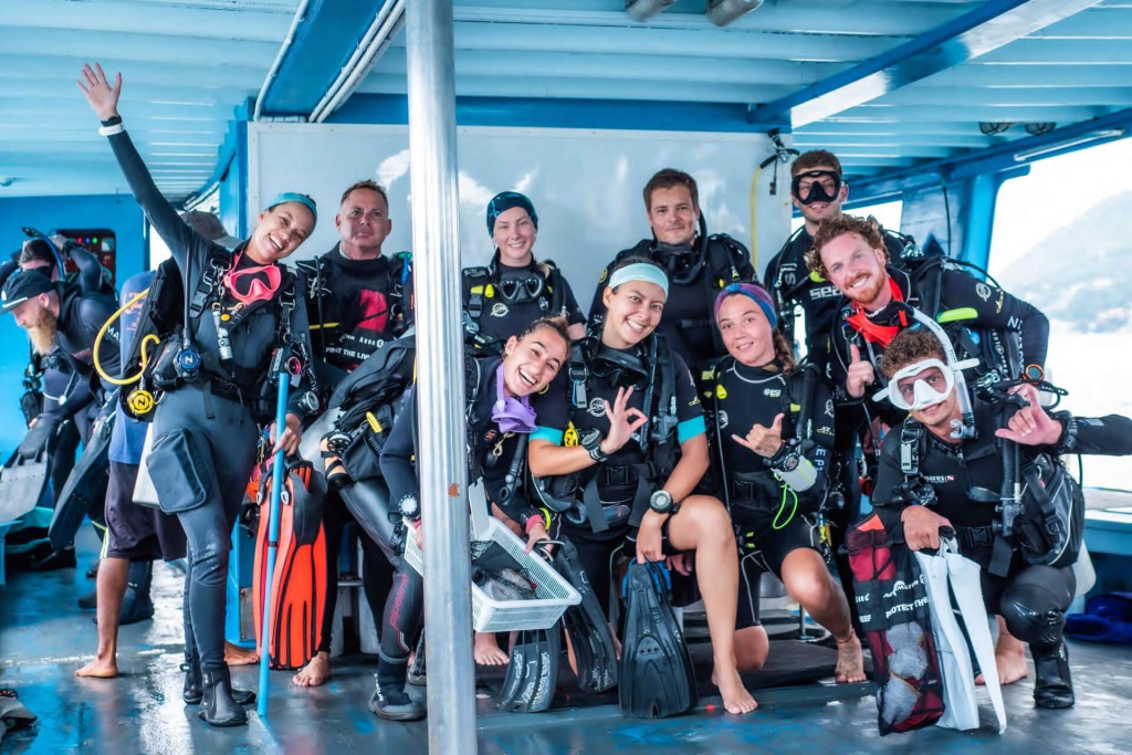 Group of marine conservation divers on the boat during the Ecological Monitoring Program (EMP) course with Black Turtle Conservation on Koh Tao, Thailand.