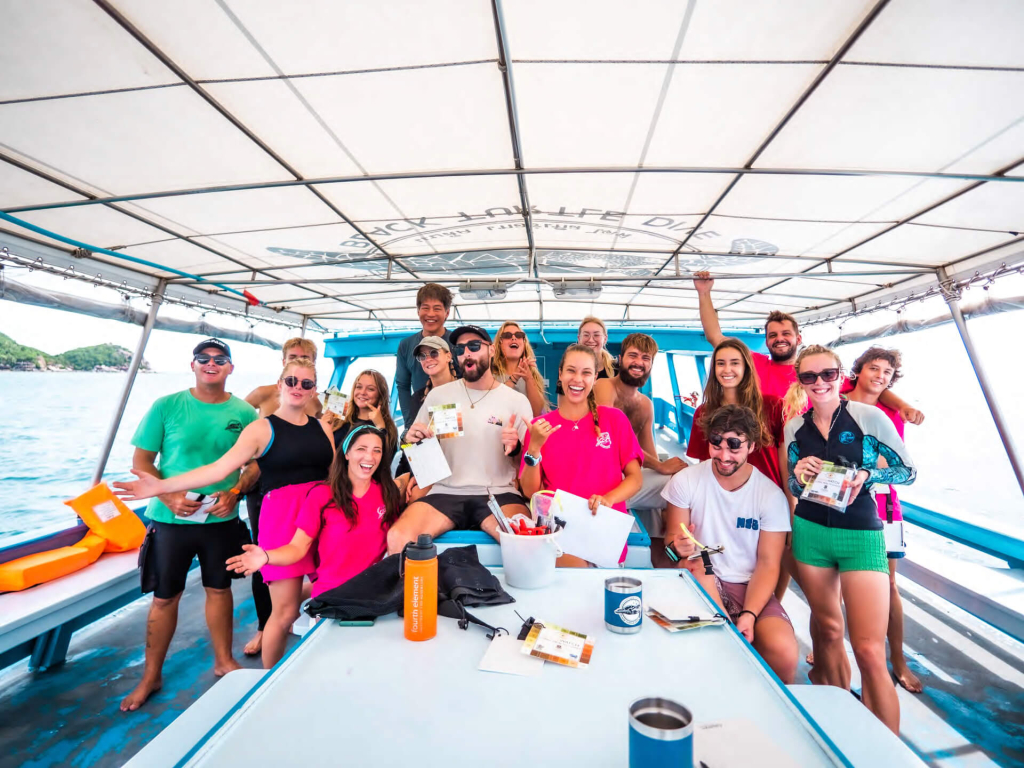 Group of marine conservation volunteers assisting with coral reef surveys at Black Turtle Conservation, Koh Tao, Thailand.