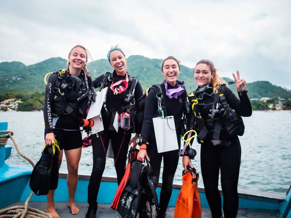 Citizen science students training in coral monitoring and reef survey skills as part of marine conservation diving in Koh Tao, Thailand.