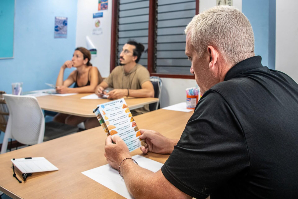 Marine conservation student identifying coral genera during field training for the Coral Taxonomy course at Black Turtle Conservation, Koh Tao, Thailand.