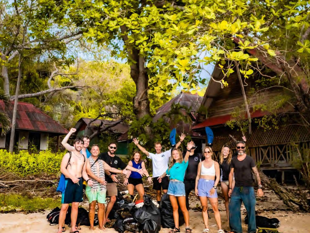 Community beach clean event in Koh Tao bringing together divers and volunteers to remove marine debris and protect coastal ecosystems.